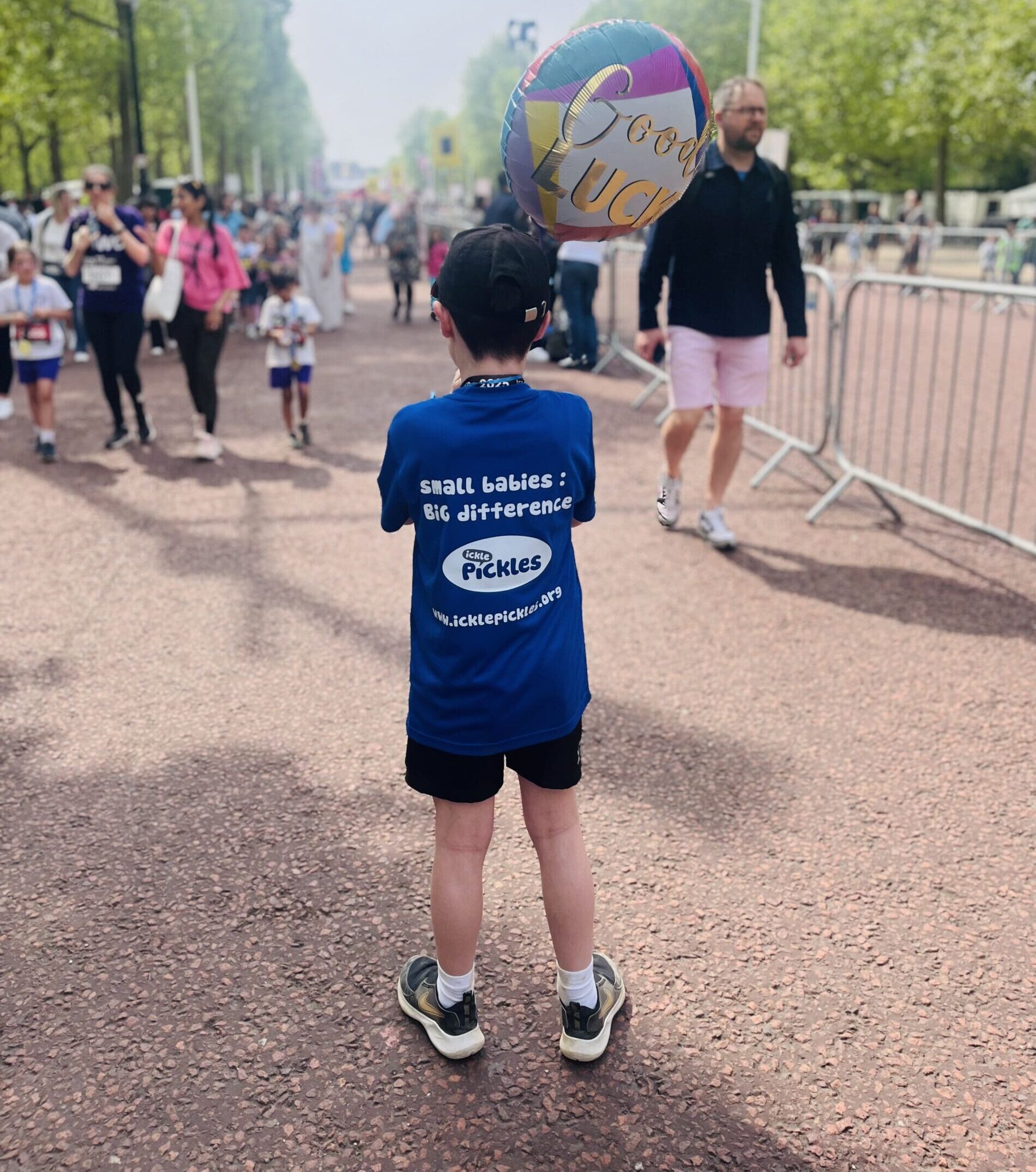 An image of a boy wearing an Ickle Pickles t-shirt at a running event