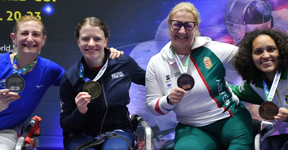 Gemma Collis with her medal and three other competitors.