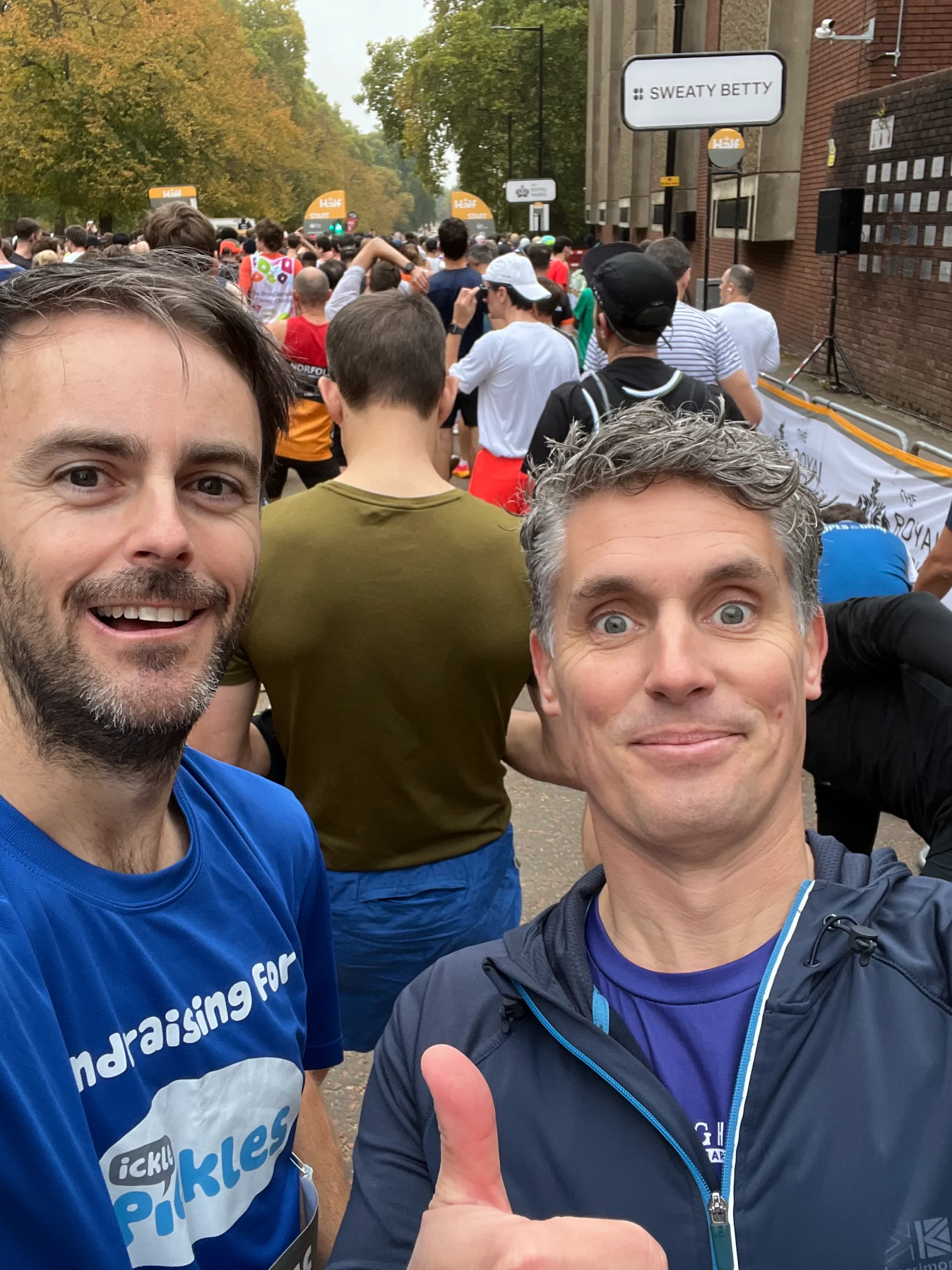 Two runners with their thumbs up wearing Ickle Pickle t-shirts.