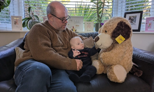 NICU Dad with toddler Laura and a giant soft toy.