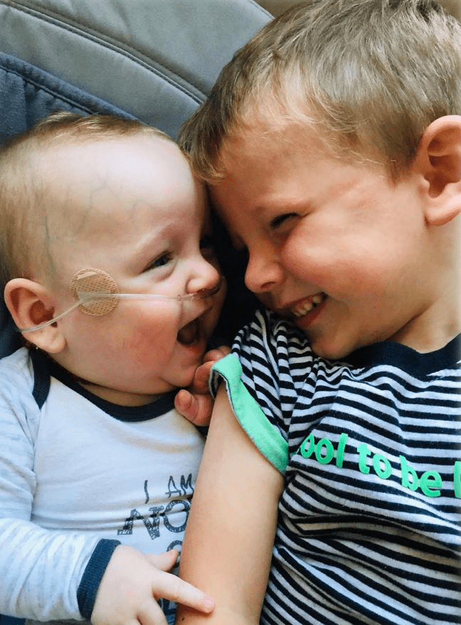 Baby Annabelle smiling with her big brother