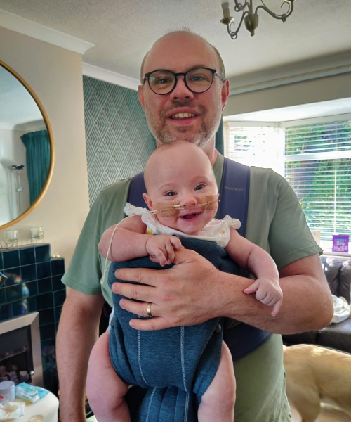 NICU Dad with baby Laura in a babycarrier.