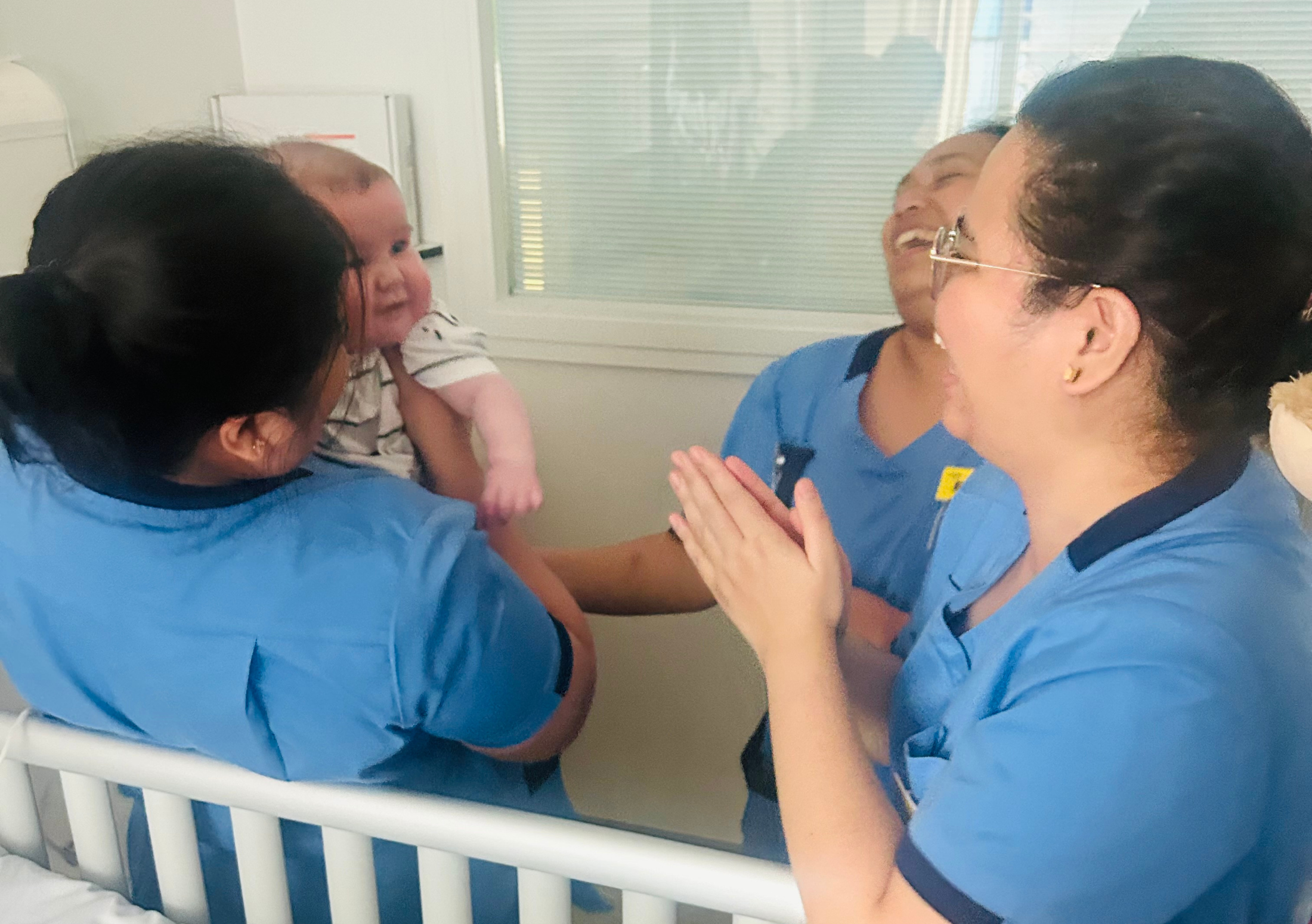 Freddie on the neonatal unit with three of his neonatal nurses