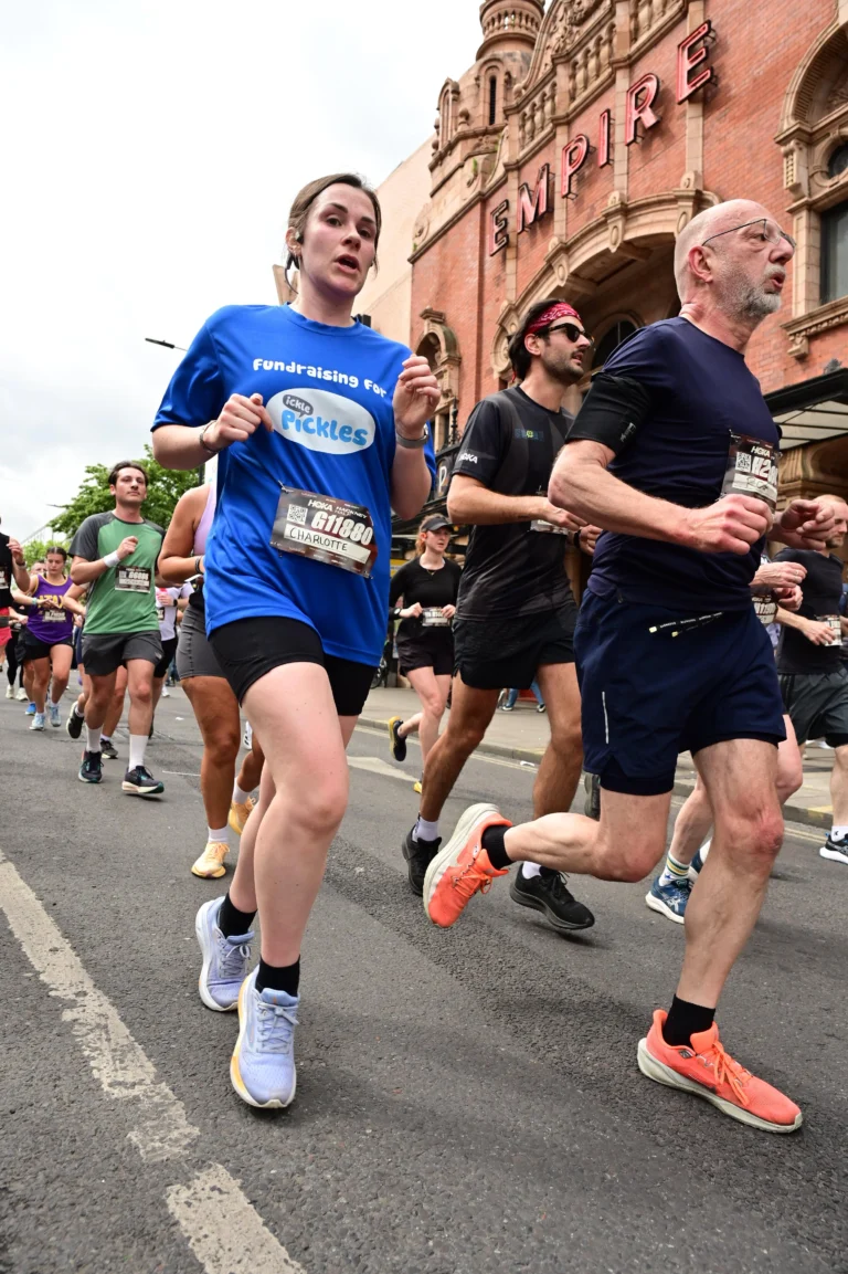 A woman wearing an Ickle Pickles top running in the Hackney Half Marathon.
