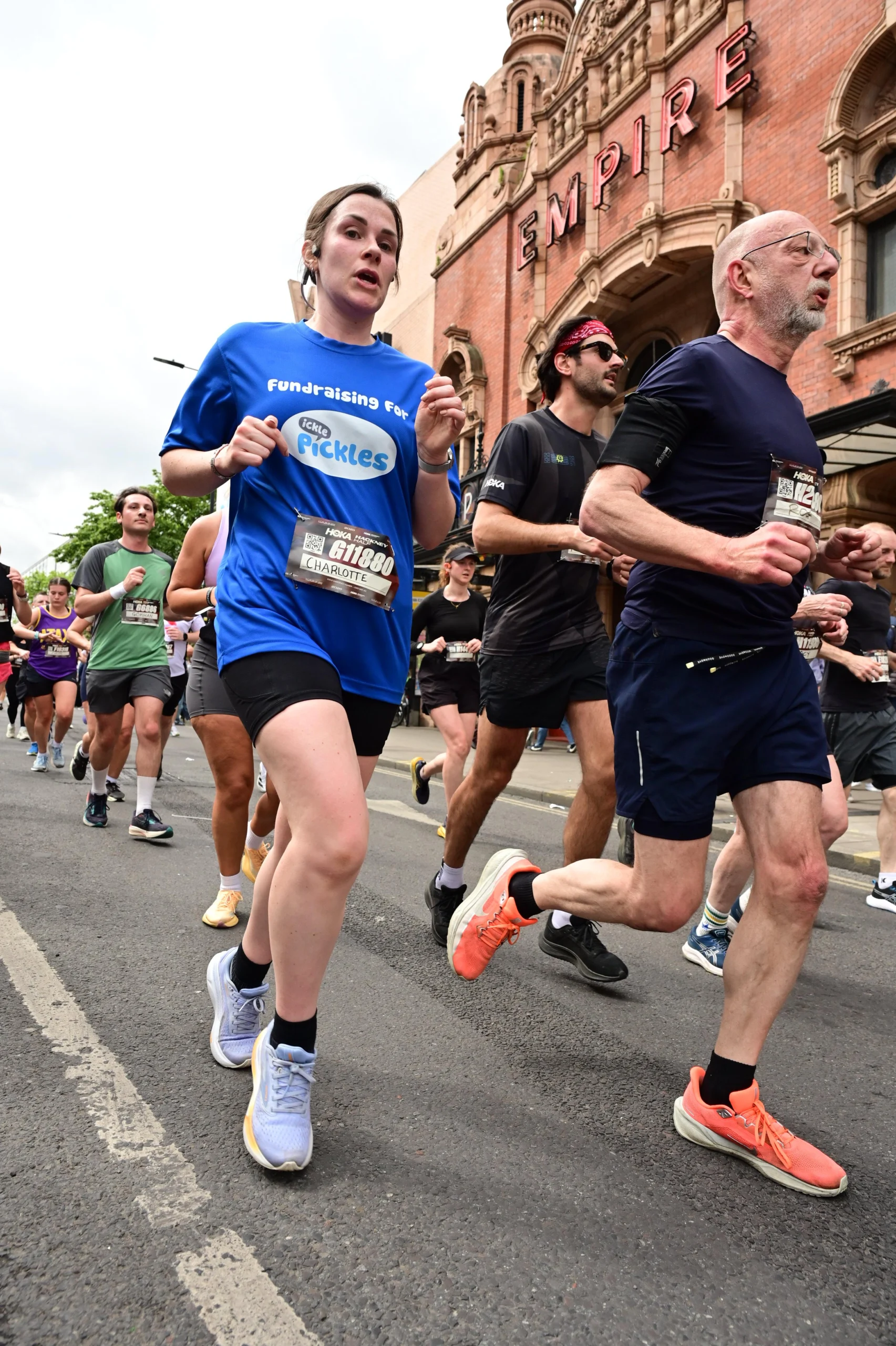 A woman wearing an Ickle Pickles top running in the Hackney Half Marathon.
