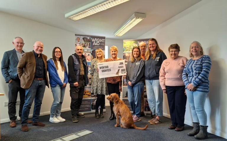 Wight Aid grant presentation - group of people with a giant cheque.