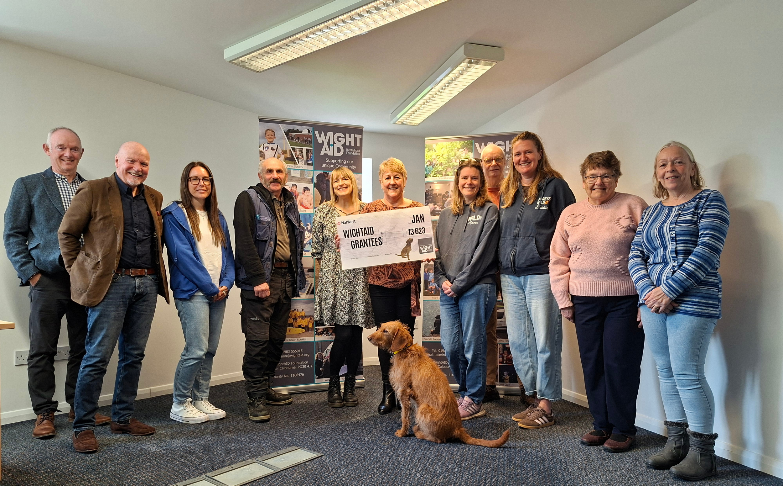 Wight Aid grant presentation - group of people with a giant cheque.